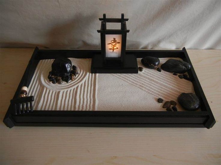 a small table with rocks and a lit lantern