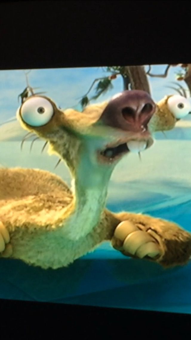 an animated character with big eyes and large teeth in front of a tv screen that is turned upside down