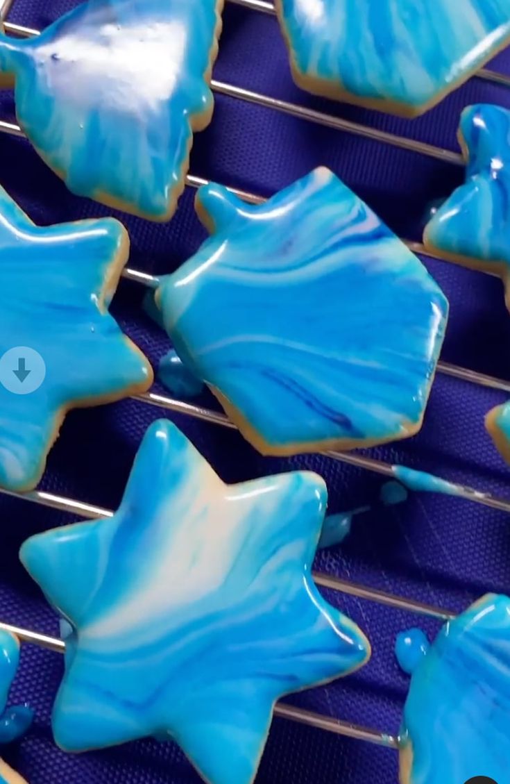 blue and white decorated cookies cooling on a rack