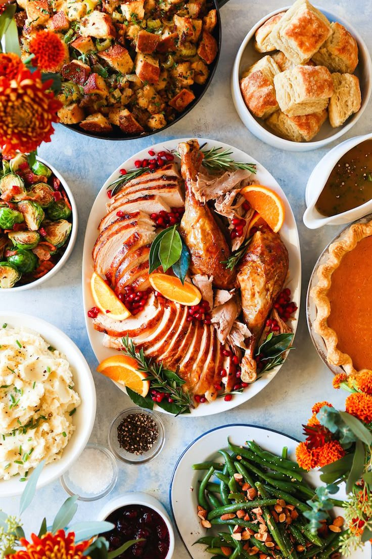 a table topped with lots of different types of food and dishes filled with meats