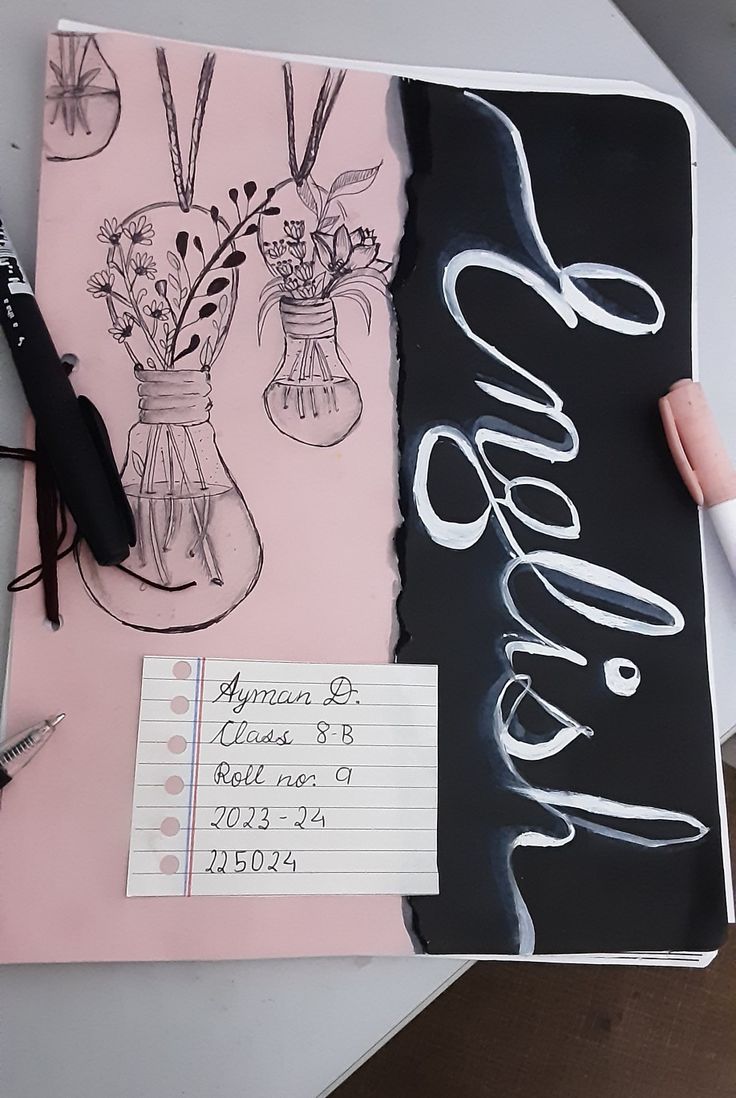 an open notebook with writing on it and flowers in vases next to a pen