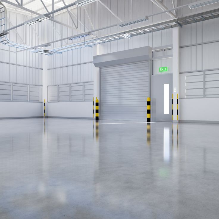 an empty warehouse with two doors and yellow caution tape on the floor in front of it