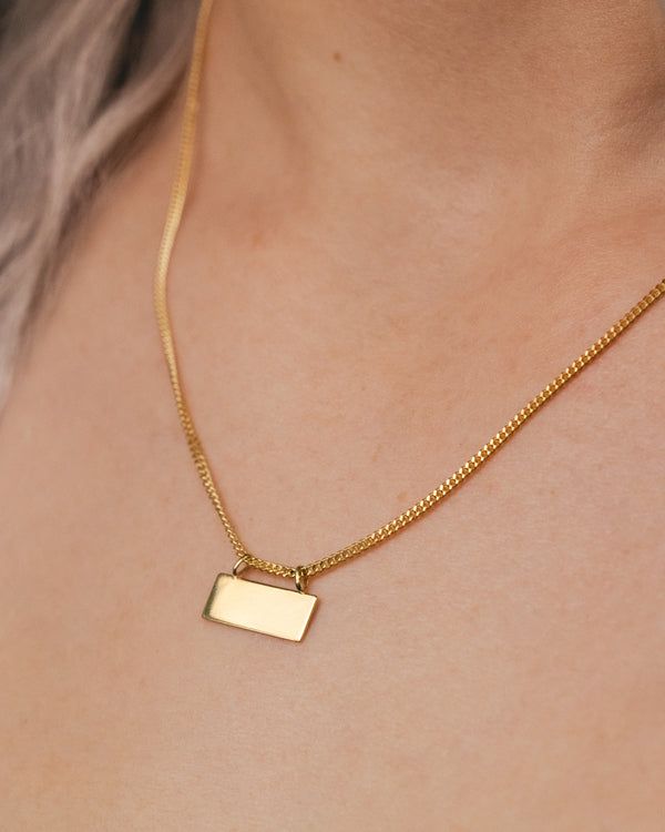 This is a gorgeous and trendy 14K gold engravable plate necklace. It is the perfect necklace to wear on its own or layered with some of your favorite pieces. This piece expertly combines classic and modern elements. The 14K yellow gold necklace features an engravable plate on an Open Curb Chain. NECKLACE DETAILS: Millimeter: 1.40 Chain Length: 18 Inches Gauge: 040 Closure: Lobster Average Weight (g): 3.88 Available in: 14K yellow gold ****These necklaces have a 4-week lead time. If you need your necklace sooner than that, please contact us prior to ordering to verify if that's possible.** | Engravable Plate On Open Curb Chain Necklace In 14K Yellow Gold Ring - by Staghead Designs - Unisex Gold Nameplate Necklace With Polished Finish, Elegant Nameplate Box Chain Jewelry, Elegant Gold Dog Tag Charm Necklace, Everyday Yellow Gold Dog Tag Jewelry, Gold Nameplate Jewelry With Box Chain, Gold Rectangular Curb Chain Necklace, 14k Gold Dog Tag Necklace, Gold Polished Dog Tag Jewelry, Luxury Gold Dog Tag Necklace