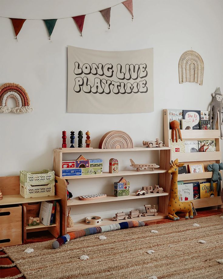 a child's playroom with toys and bookshelves in front of a poster on the wall