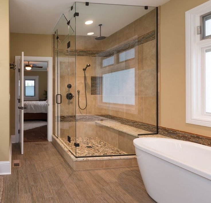 a bath room with a tub and a window