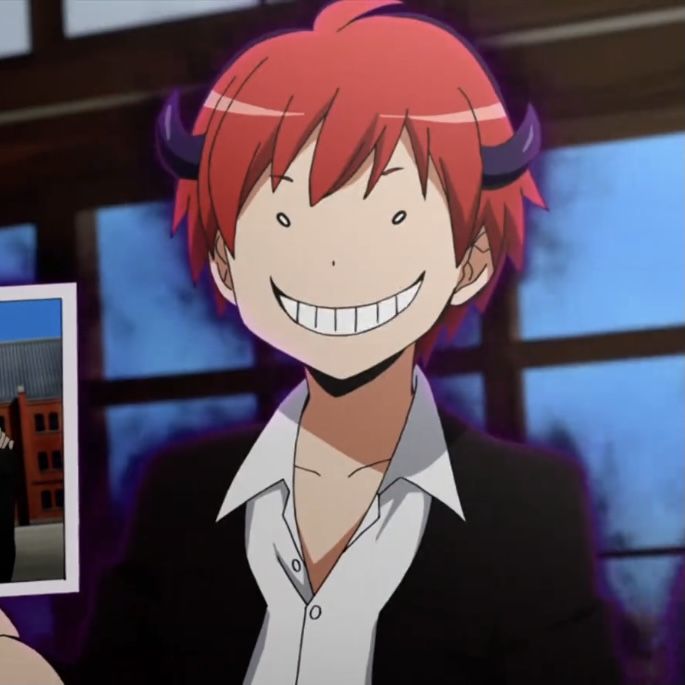 an anime character with red hair smiling and holding up a photo in front of him