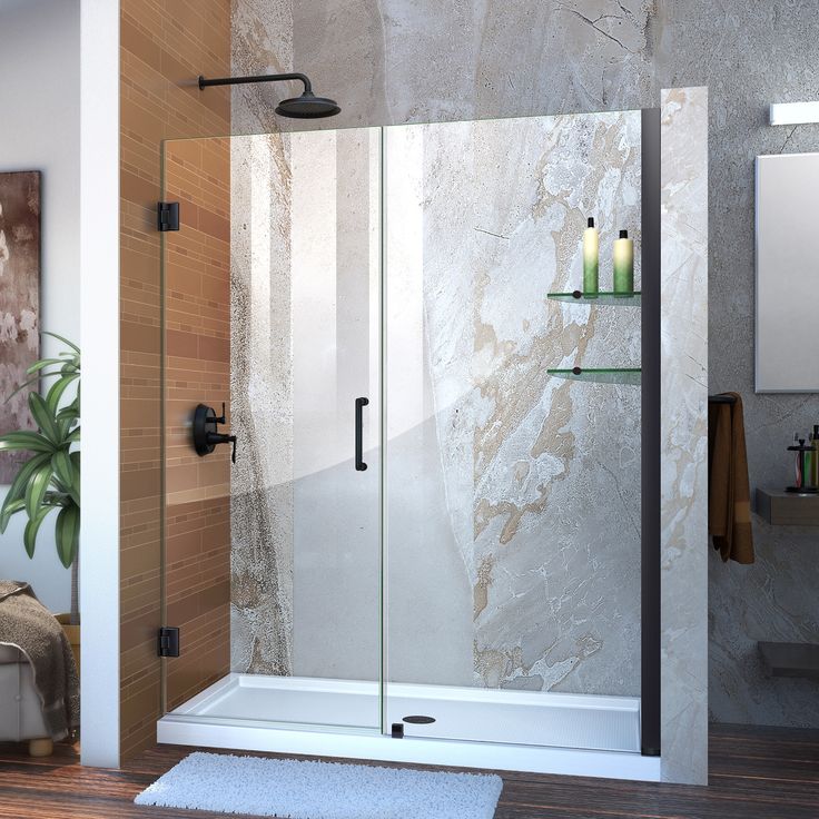 a bathroom with a glass shower door and wood flooring on the walls, along with a white rug