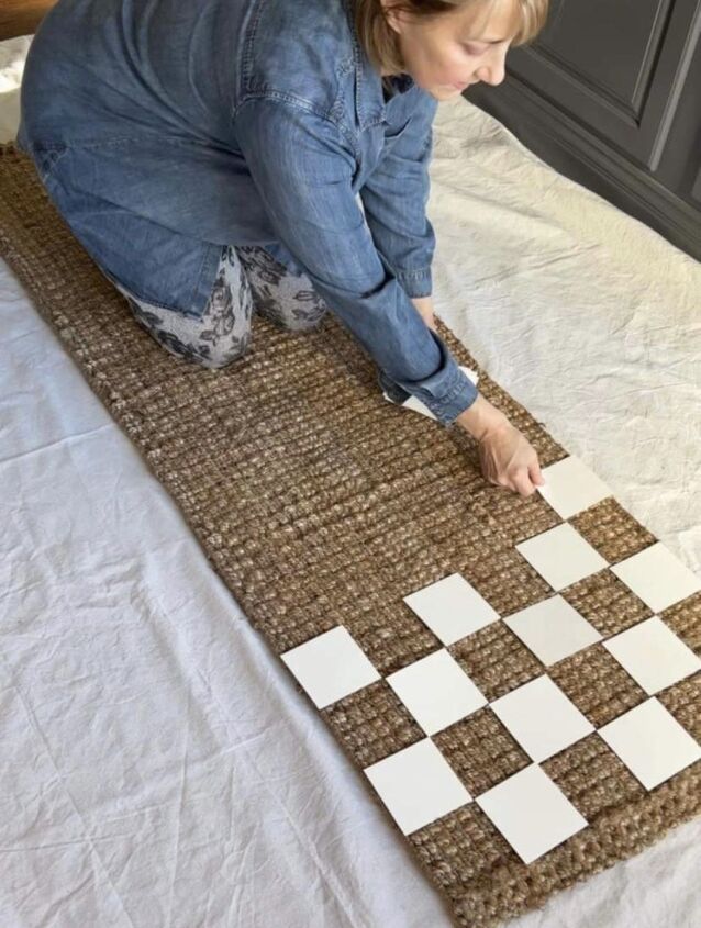 a woman laying on top of a checkered rug