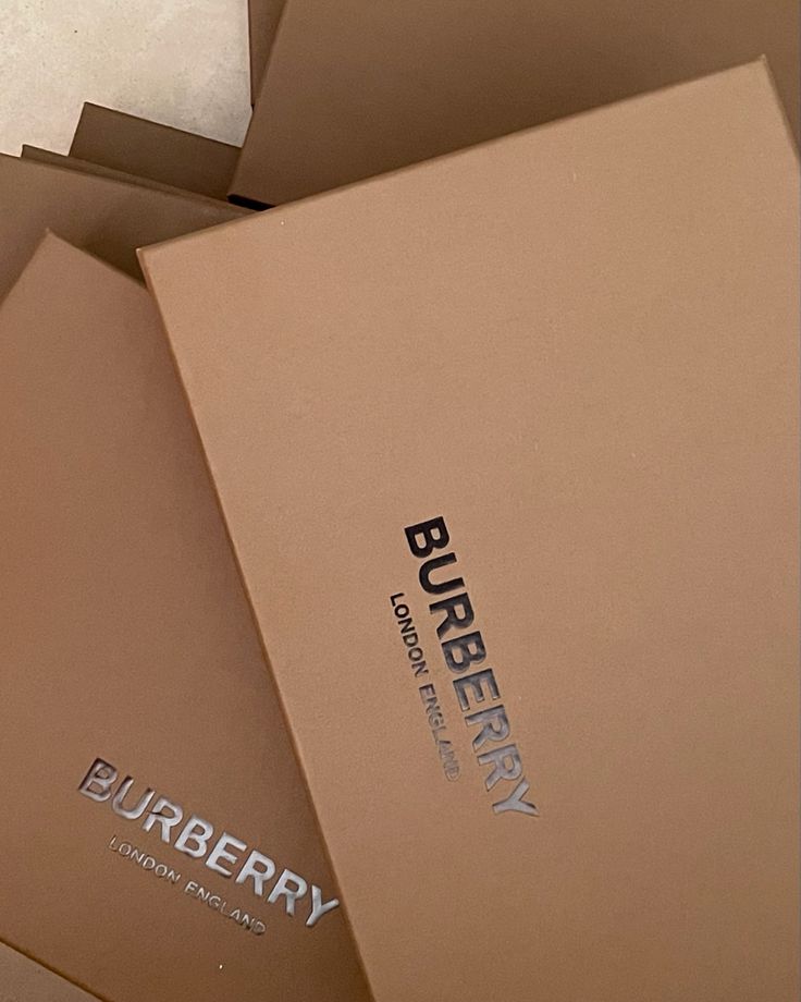 three boxes are stacked on top of each other with the words burberry printed on them