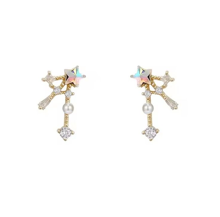 Shooting Star Stud Earrings - where elegance meets simplicity in the most charming way. Handcrafted with meticulous attention to detail, these earrings are the epitome of understated sophistication! Each earring features an iridescent star, cubic zirconia trail, 18K gold-plated setting; giving additional sparkle to each motion. The smooth, 18k gold plate will reduce allergies for sensitive ears.   Embrace the energy of the star and add a touch of sophistication to your jewelry collection today! Elegant Sparkling Star Crystal Earrings, Elegant Star-shaped Sparkling Crystal Earrings, Elegant White Star-shaped Pearl Earrings, White Star-shaped Cubic Zirconia Earrings, Elegant Party Earrings With Star Charm, Elegant Star Charm Earrings For Party, Elegant Star-shaped Sparkling Earrings, Star-shaped Cubic Zirconia Earrings For Party, Star Shaped Cubic Zirconia Earrings For Party