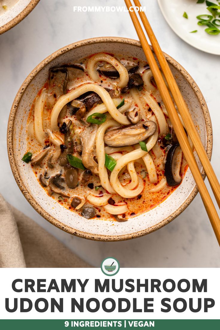 creamy mushroom udon noodle soup in a bowl with chopsticks on the side