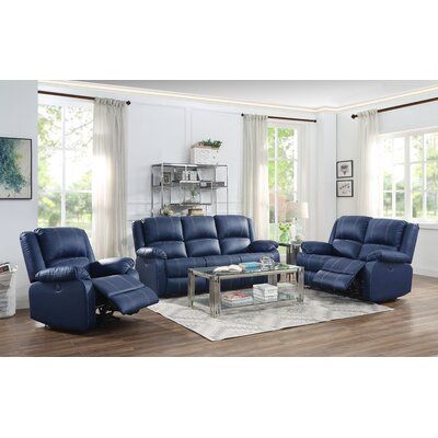 a living room with blue leather furniture in it