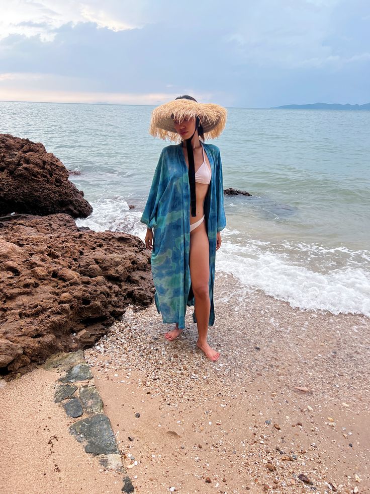 Enhance your everyday style with the subtle allure of patterns and colors in our Dragon Tie Dye Kimono Jacket, inspired by the ocean. This kimono robe effortlessly embodies chic resort-style vibes while ensuring comfort. Hand-stitched from 100% soft rayon fabric and meticulously tie-dyed by skilled artisans, it boasts both quality craftsmanship and artistic flair. With a dropped hemline and a flowing oversized fit, this long kimono jacket effortlessly infuses a laid-back, cool aesthetic into all Vacation Beach Cover-up Kimono With Kimono Sleeves, Blue Open Front Cover-up For Vacation, Casual Blue Beach Kimono, Blue Wrap Kimono For Summer, Casual Blue Kimono For Beach, Blue Long Kimono For Vacation, Long Blue Kimono For Vacation, Blue Kimono For Beach, Blue Wrap Kimono For Beach Cover-up