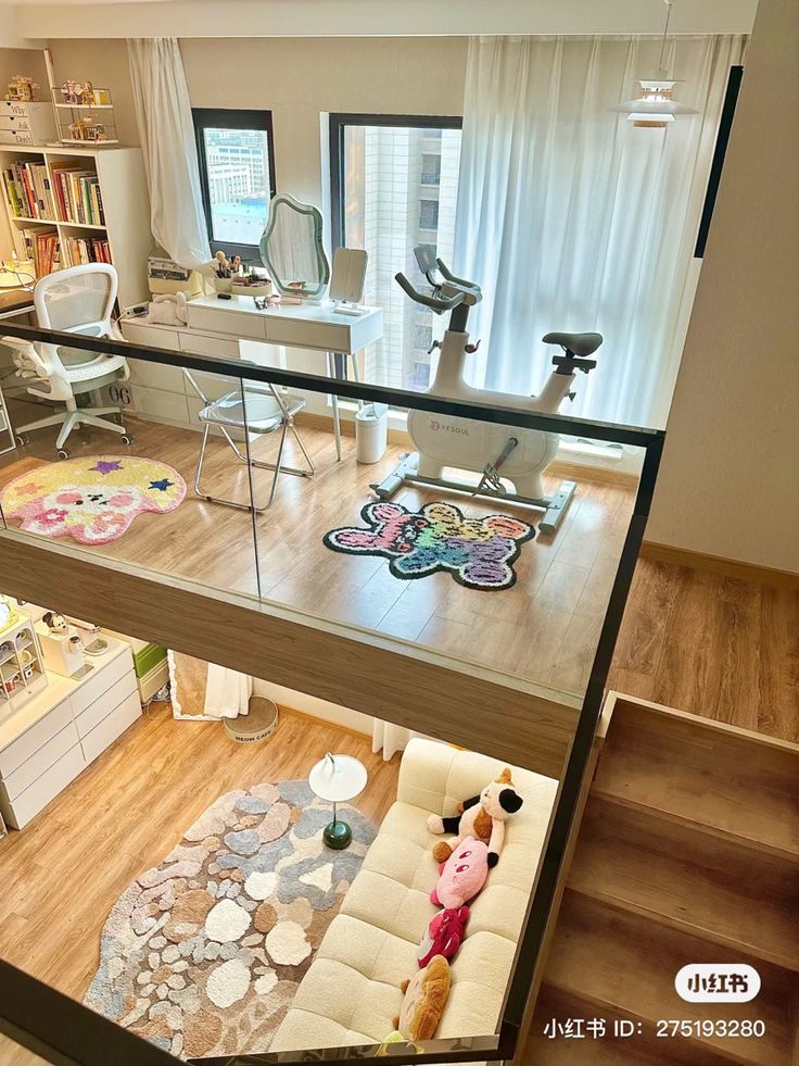 an aerial view of a living room and office area from the second floor looking down