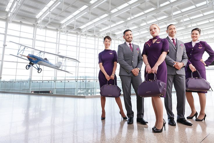 a group of flight attendants standing next to each other