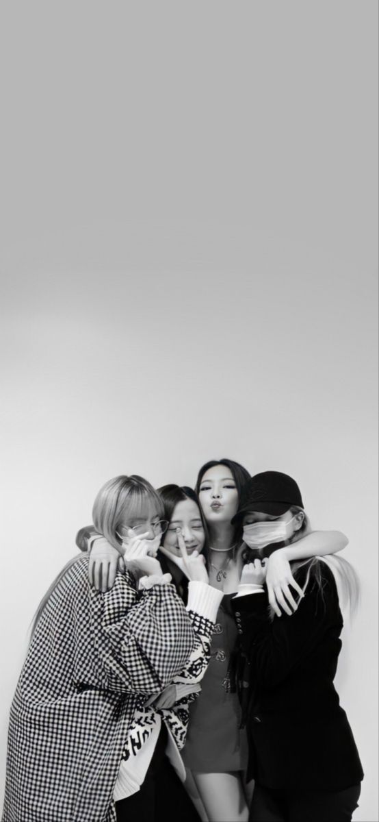 three women hugging each other in front of a white background