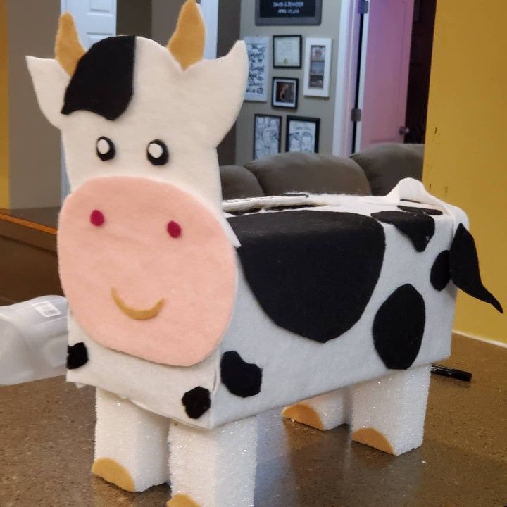 a cow made out of toilet paper sitting on top of a table