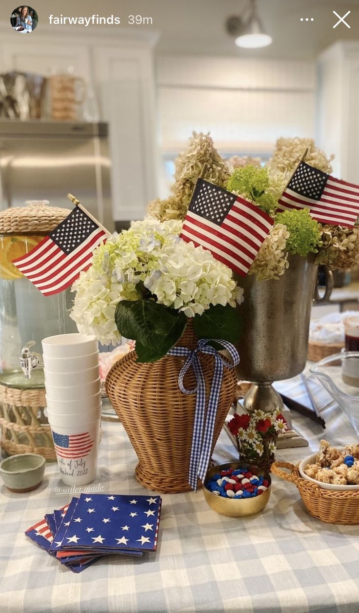 an american flag centerpiece is displayed on a table with other patriotic items and decorations