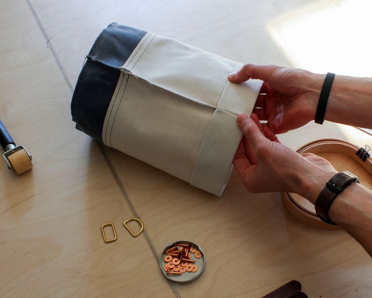 a person is wrapping something in a bag on the table next to some other items