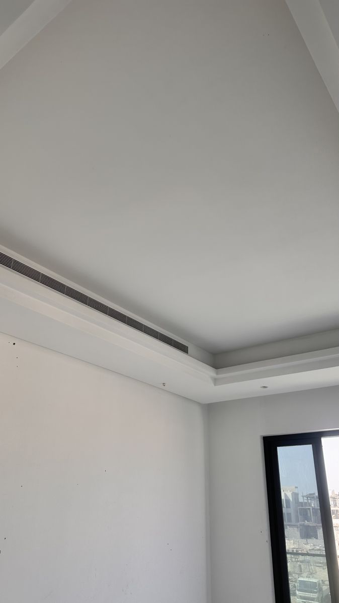 an empty room with white walls and black trim on the ceiling is pictured in this image