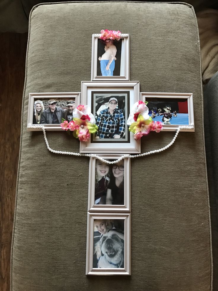 a cross decorated with flowers and photos