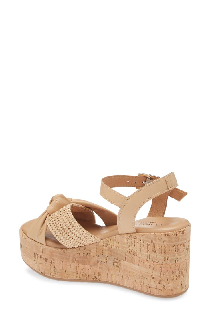 A cork-textured platform enhances the earthy style of a lightly cushioned sandal topped with leather and raffia straps. 3" heel; 1 1/2" platform Cushioned footbed Leather and raffia upper/leather lining/rubber sole Made in Italy Cork Open Toe Wedge Sandals For Beach, Open Toe Cork Wedge Sandals For Beach, Cork Wedge Heel Sandals For Summer, Chic Cork Wedge Sandals With Open Toe, Cork Wedge Sandals For Summer, Chic Open Toe Cork Wedge Sandals, Spring Beach Wedge Sandals With Cork Material, Summer Cork Wedge Sandals With Open Toe, Summer Open Toe Cork Wedge Sandals