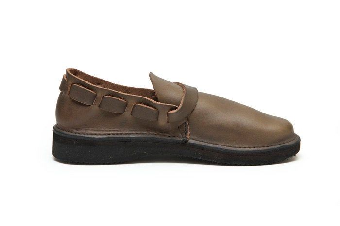 "Handmade in Aurora, New York. Tried and true, the Middle English is a monk style flat that is the very definition of comfort. The full grain, leather construction molds to your foot with wear, and the Vibram rubber sole lets you walk comfortably for miles. This simple style can be appropriate for any occasion. This is the trademark shoe that we have been producing for 20+ years. Our trademark adjustable strap weaves around the back of the heel and closes on a solid brass buckle. Available in 5 Casual Leather Monk Strap Shoes With Rubber Sole, Casual Slip-on Monk Strap Shoes With Removable Insole, Casual Brown Monk Strap Shoes With Leather Footbed, Casual Brown Monk Strap Shoes With Leather Sole, Casual Monk Strap Shoes With Leather Sole, Casual Leather Monk Strap Shoes With Plain Toe, Casual Leather Slip-on Monk Strap Shoes, Casual Slip-on Leather Monk Strap Shoes, Casual Monk Strap Shoes With Leather Footbed