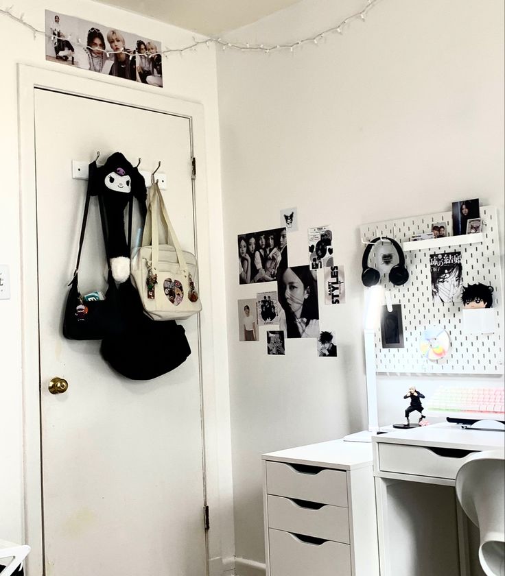 a room with white walls and pictures on the wall, including an open closet door