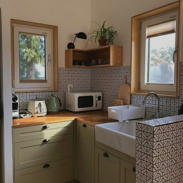 a kitchen area with sink, microwave and cabinets