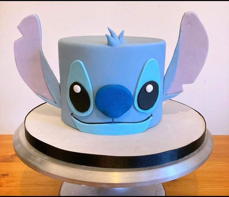 a blue hat with ears and eyes on top of a table