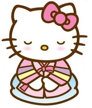 a hello kitty sitting on top of a plate with a bow in it's hair