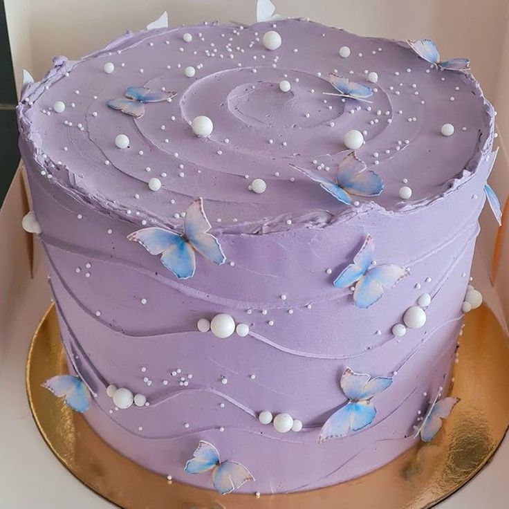 there is a purple cake with butterflies on it