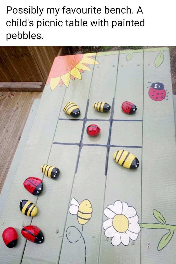 a wooden table topped with lots of different kinds of magnets on top of it