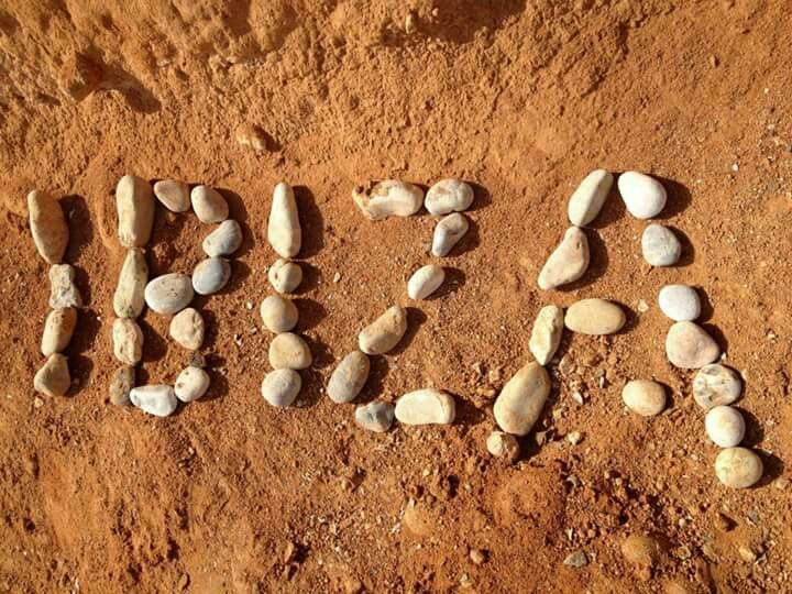 rocks spelling out the word faith on top of dirt and gravel with small stones scattered around it