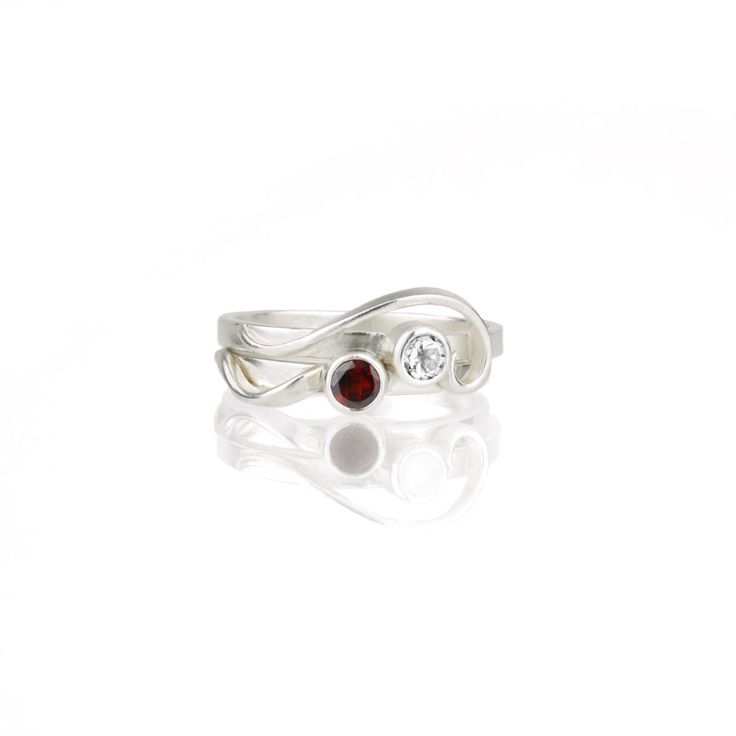 The so-called "whiplash line" is one of the defining hallmarks of the Art Nouveau style. Here, the whiplash curves in a graceful arabesque around a sparkling gemstone and entwines around your finger. The Arabesque Ring is dainty and elegant when worn alone; but this slender stacking ring is designed to nestle closely with one or more accompanying bands. This sparkly white sapphire and sterling silver ring is handcrafted and made to order. Wear it by itself, or customize a stack of skinny bands a Elegant Spiral Bypass Ring, Elegant Adjustable Birthstone Ring In Sterling Silver, Elegant Adjustable Sterling Silver Birthstone Ring, Adjustable Elegant Sterling Silver Birthstone Ring, Modern Twist Spiral Jewelry For Anniversary, Elegant Swirl Anniversary Rings, Elegant Swirl Shaped Wedding Jewelry, Elegant Sterling Silver Bypass Wedding Ring, Elegant Sterling Silver Bypass Ring For Wedding