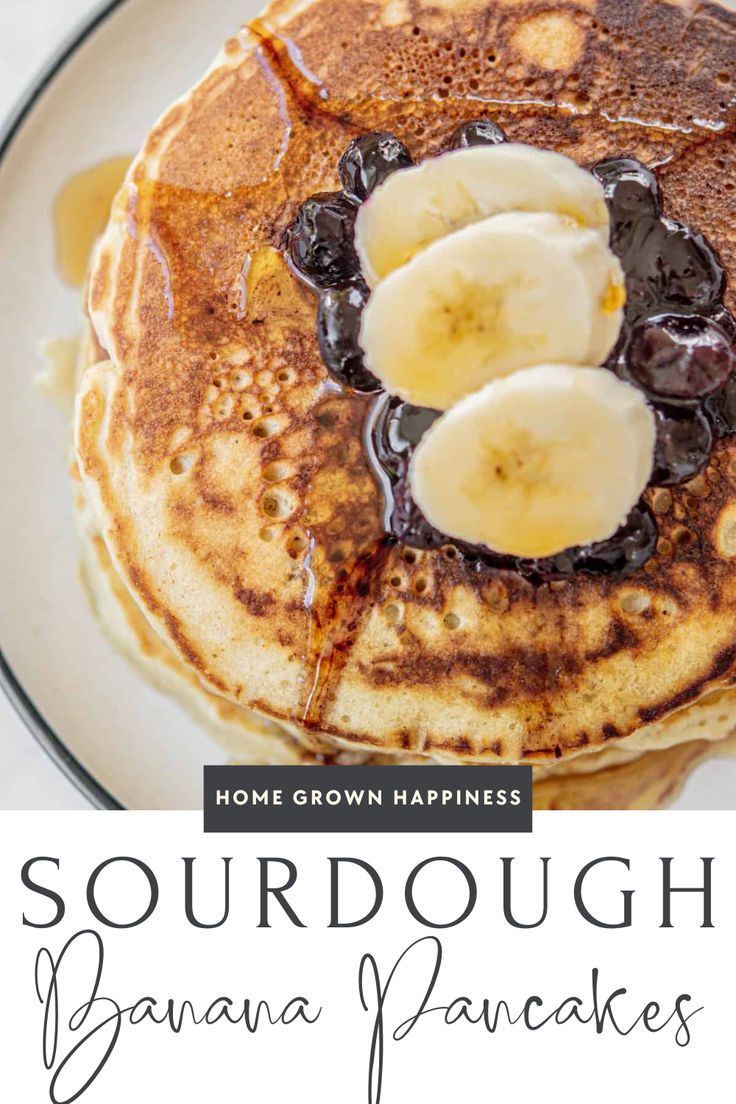 some pancakes with bananas and syrup are on a plate that says sourdough banana pancakes