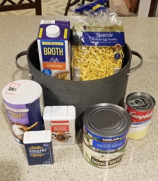 a bucket filled with food sitting on top of a kitchen counter next to other items