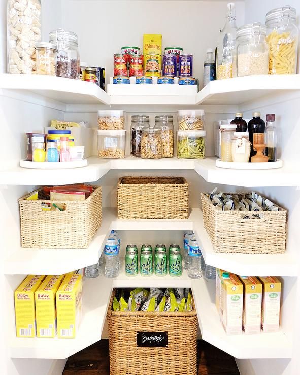 an organized pantry with lots of food and drinks in baskets on the shelves, along with other items