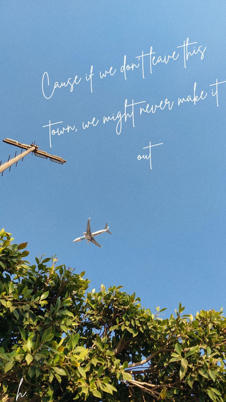 an airplane flying in the sky with a quote written on it's back side