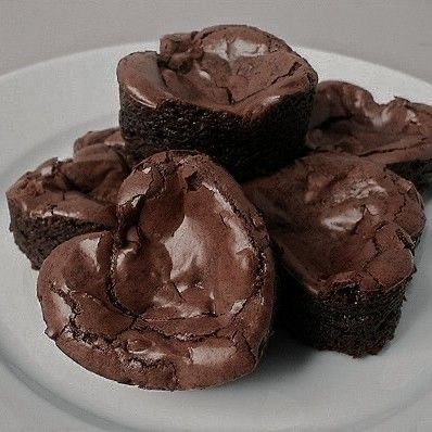 three chocolate brownies on a white plate