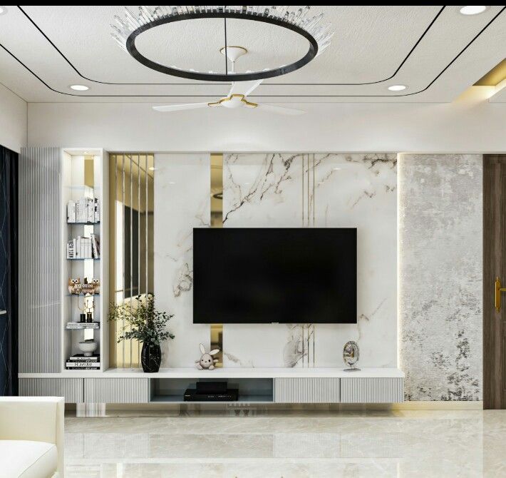 an elegant living room with marble walls and flooring, white couches and a flat screen tv mounted on the wall