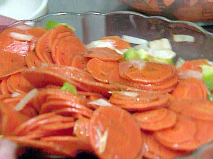 a bowl filled with sliced carrots and onions