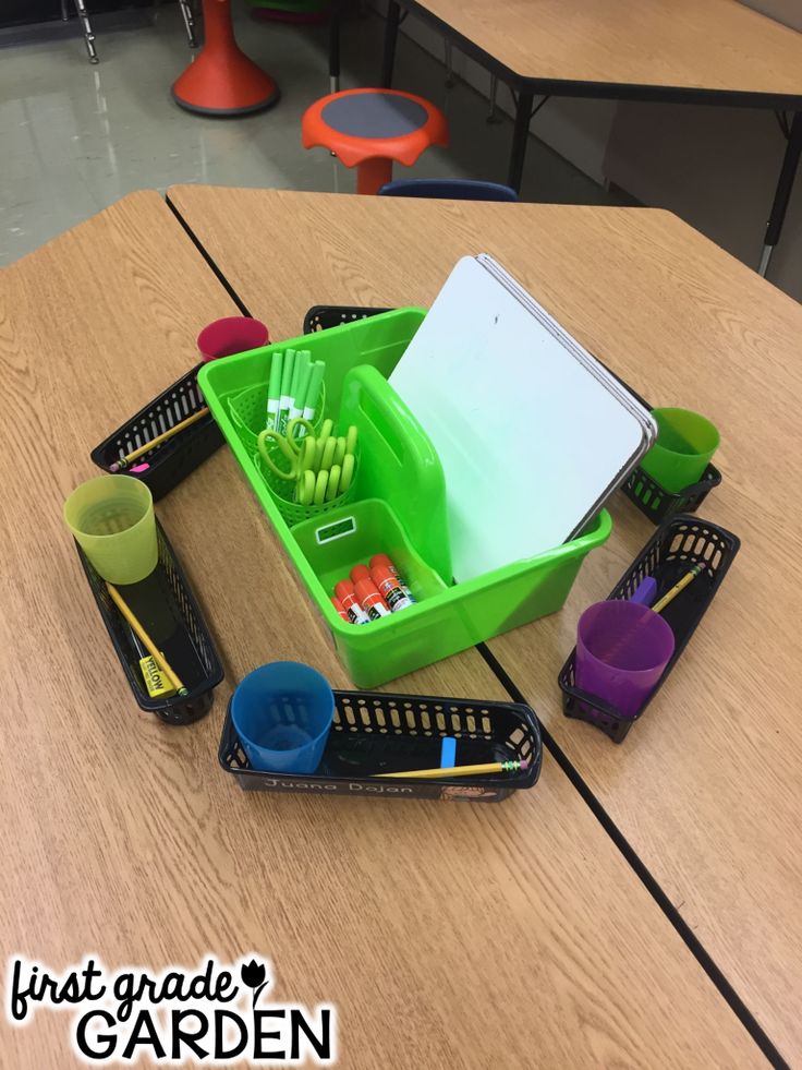 a green container filled with pens and pencils sitting on top of a wooden table