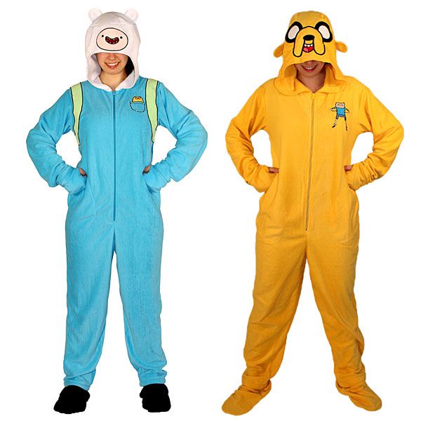 three people in pajamas are standing with their hands on their hipss and wearing animal onesuits