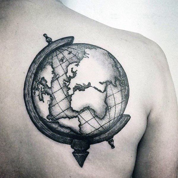 a man with a tattoo on his chest holding a globe