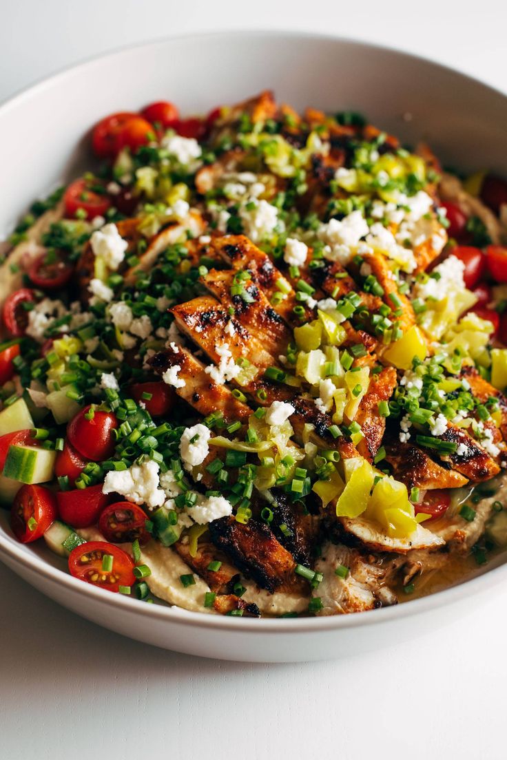 a white bowl filled with food on top of a table