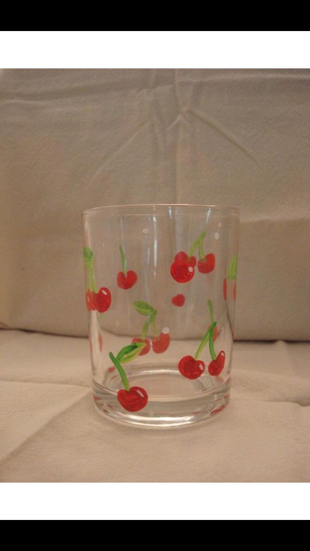 a glass with cherries painted on it