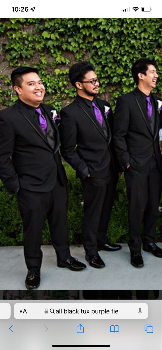 a group of men in suits standing next to each other on a cell phone screen