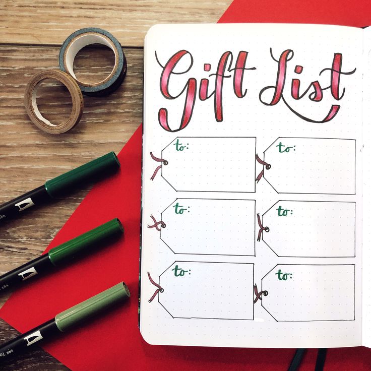 a notepad with the words gift list written on it next to some pens and scissors