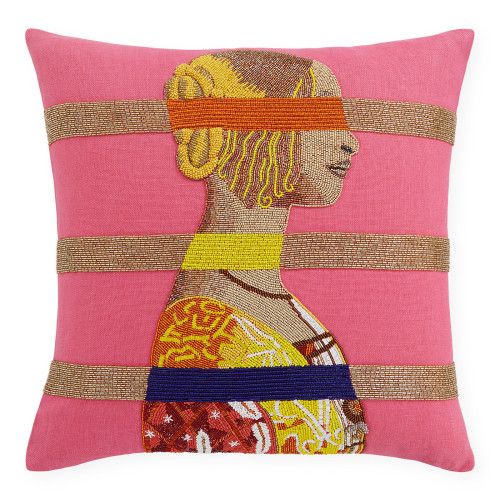 a pink pillow with an image of a woman's head on the front and side